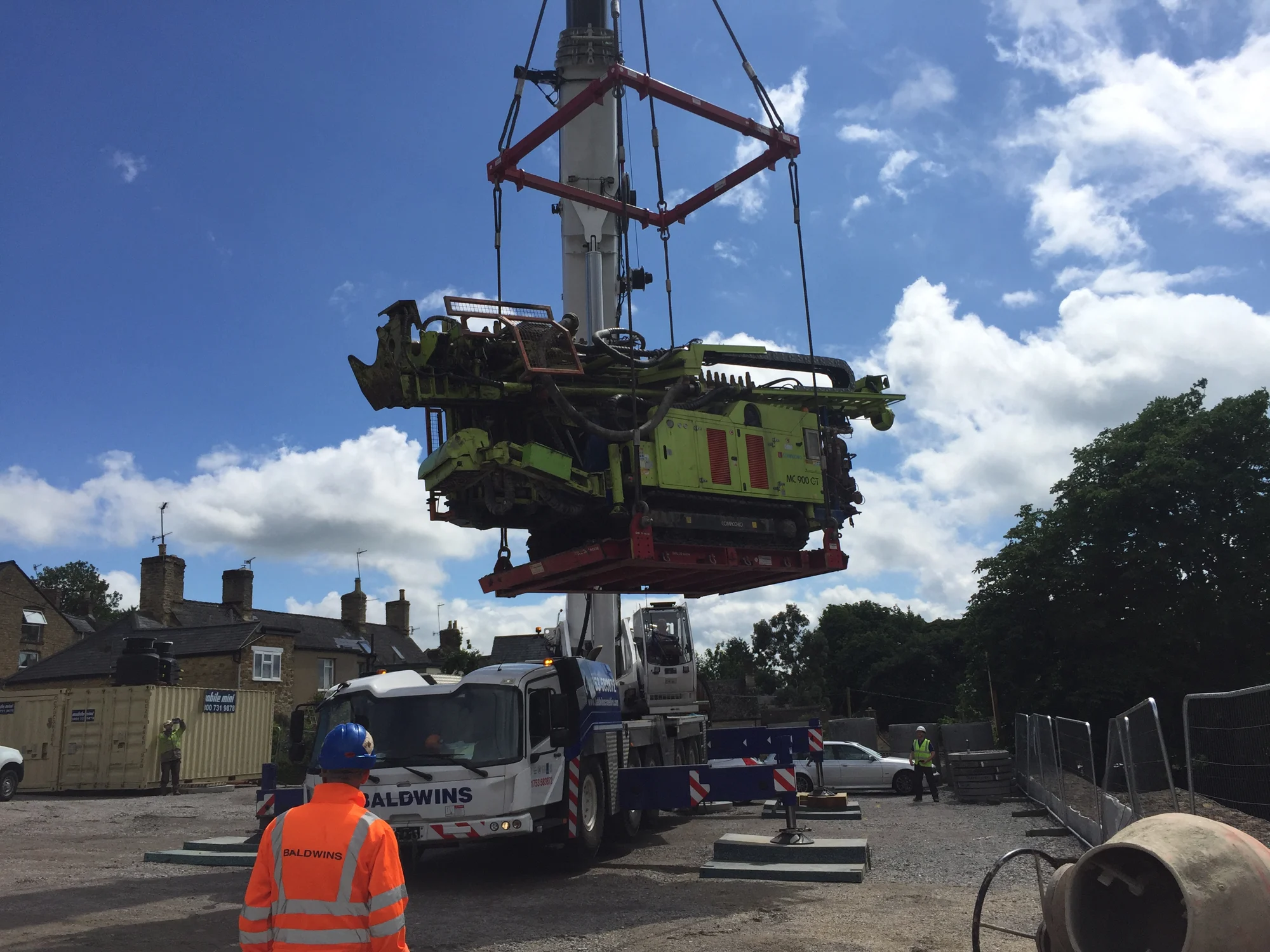 A specialist drilling rig being craned into position on a constrained site