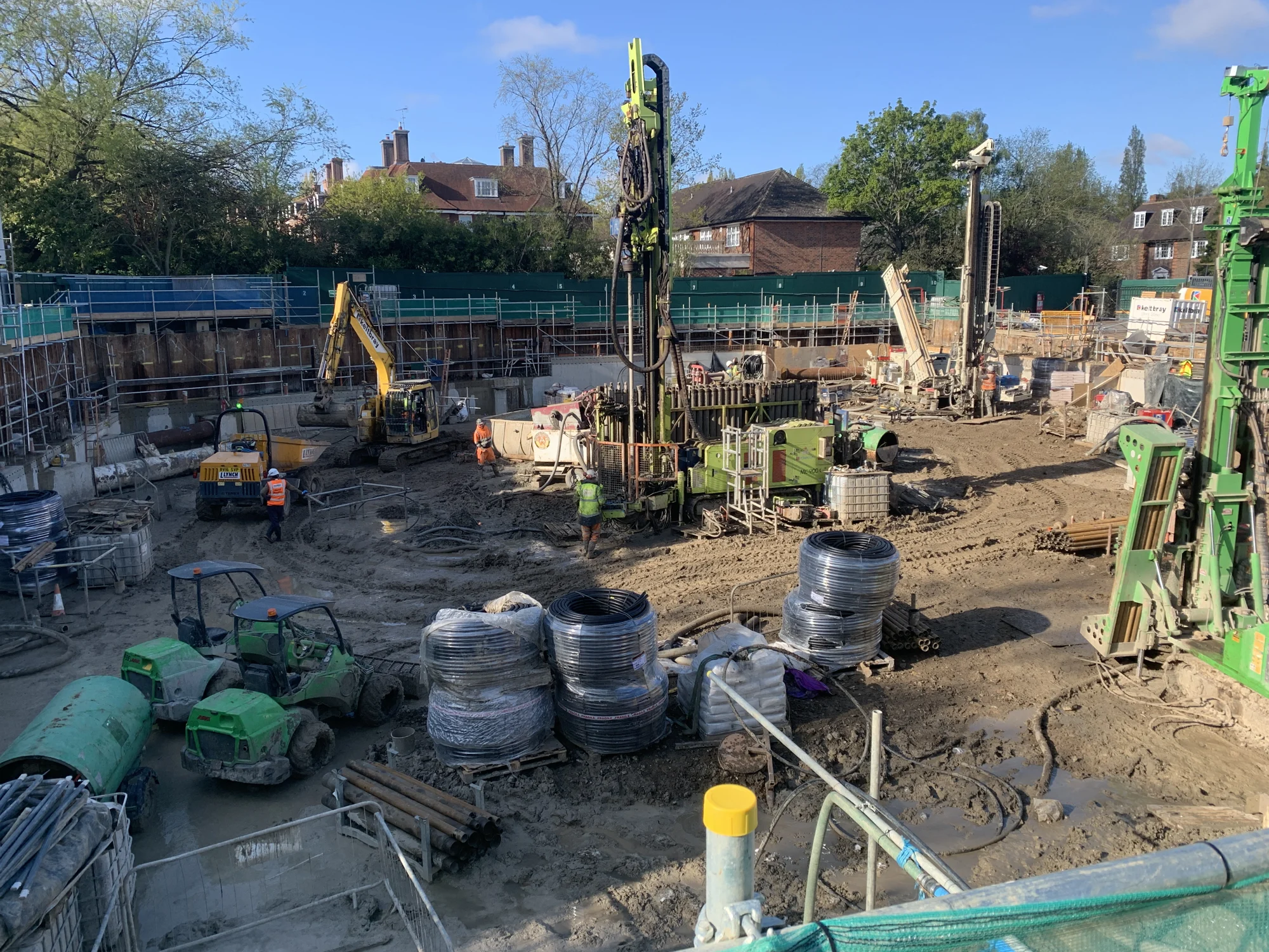 Drilling rigs and groundworks across a construction site