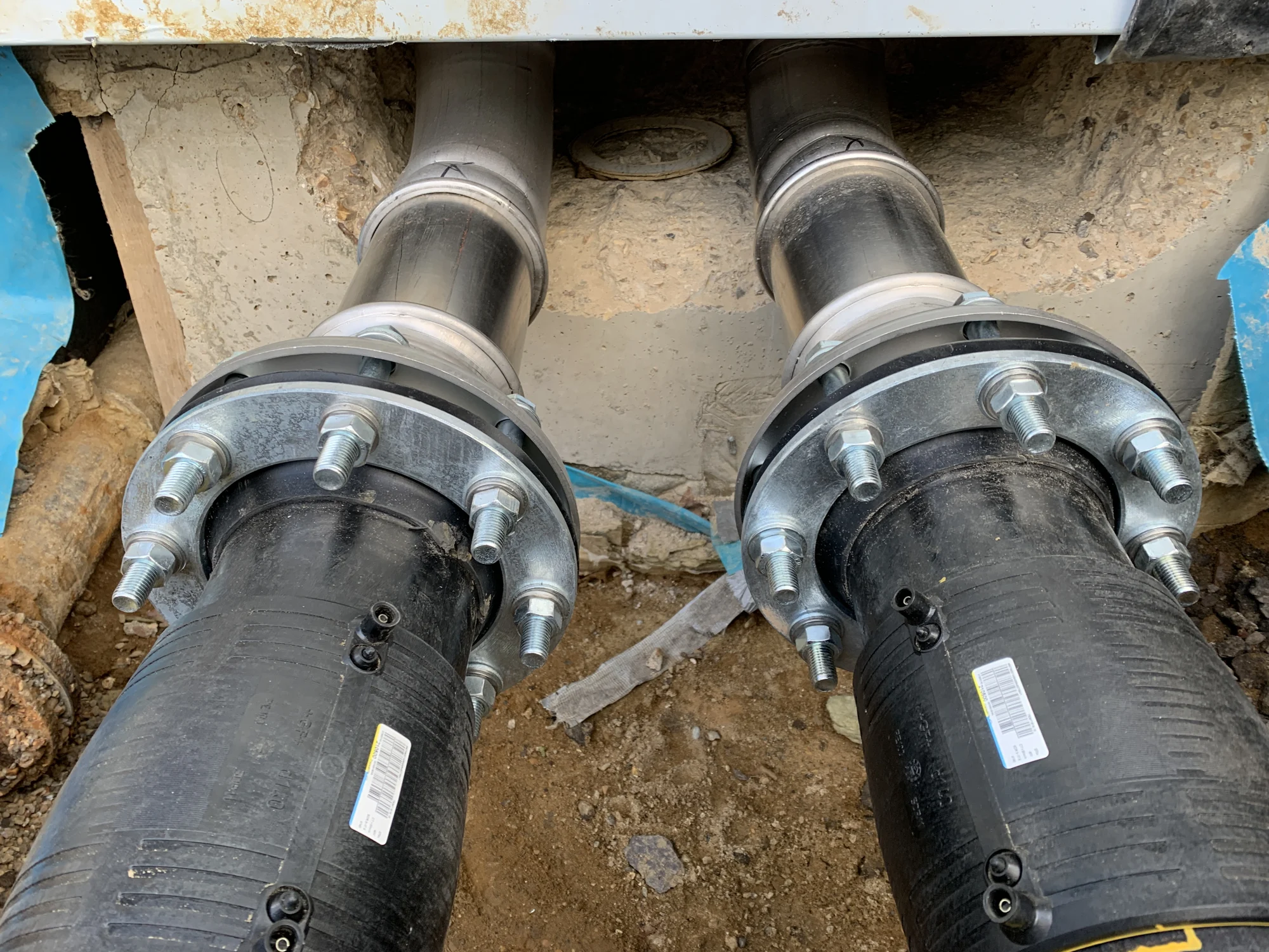 Large pipe connections installed through a wall