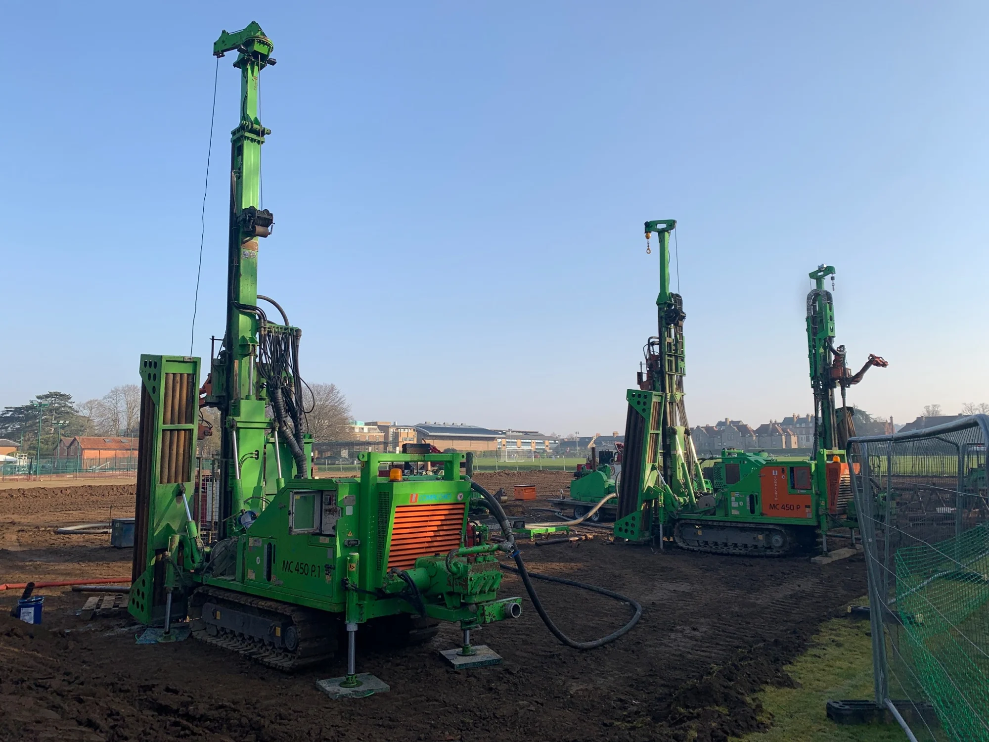 Multiple drilling rigs positioned across a field